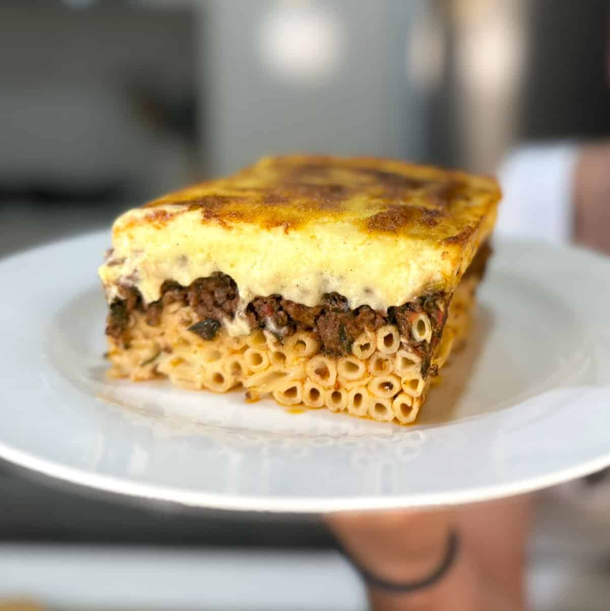 slice of greek pastitsio on  a plate ready for eating