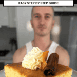 niko holding a slice of greek ravani cake ready to be eaten