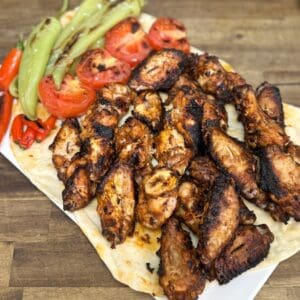 greek charcoal chicken wings served with roast vegetables