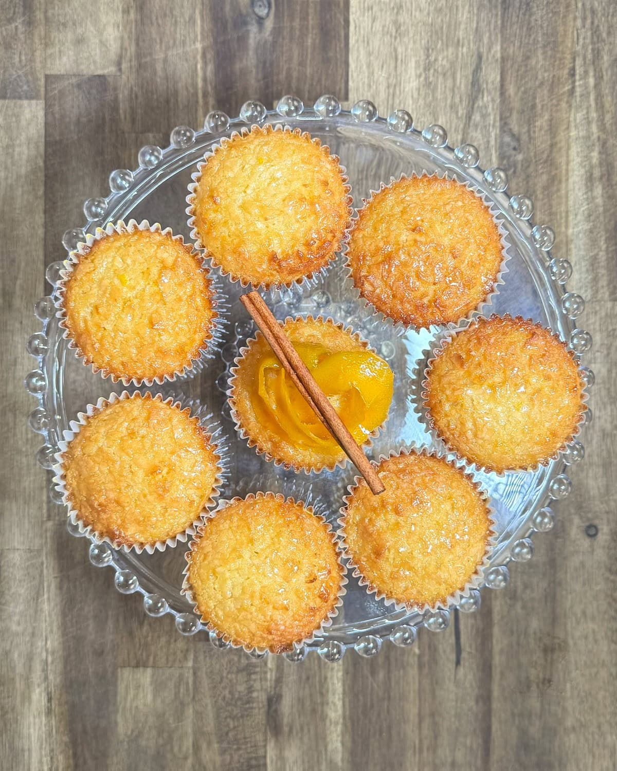 baked orange cupcakes on a cake stand