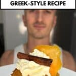 niko holding a greek orange cupcake garnished with cream, orange and cinnamon